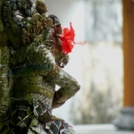 Temple statue with flower